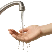 a hand pouring water from a faucet