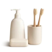 a white bottle and a white soap and a white toothbrush in a white cup