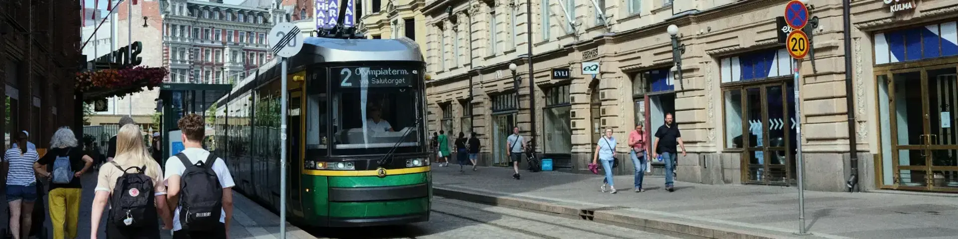 a green trolley on a street