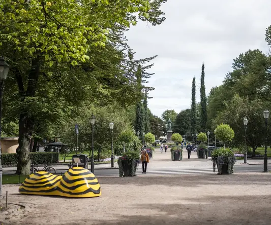 a park with a statue of a shoe